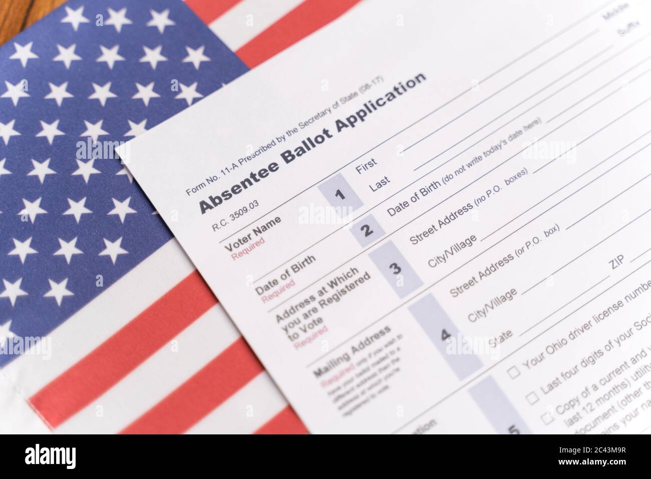 Maski, India - 23, June 2020 : Absentee ballot application on US flag for American Presidential elections Stock Photo