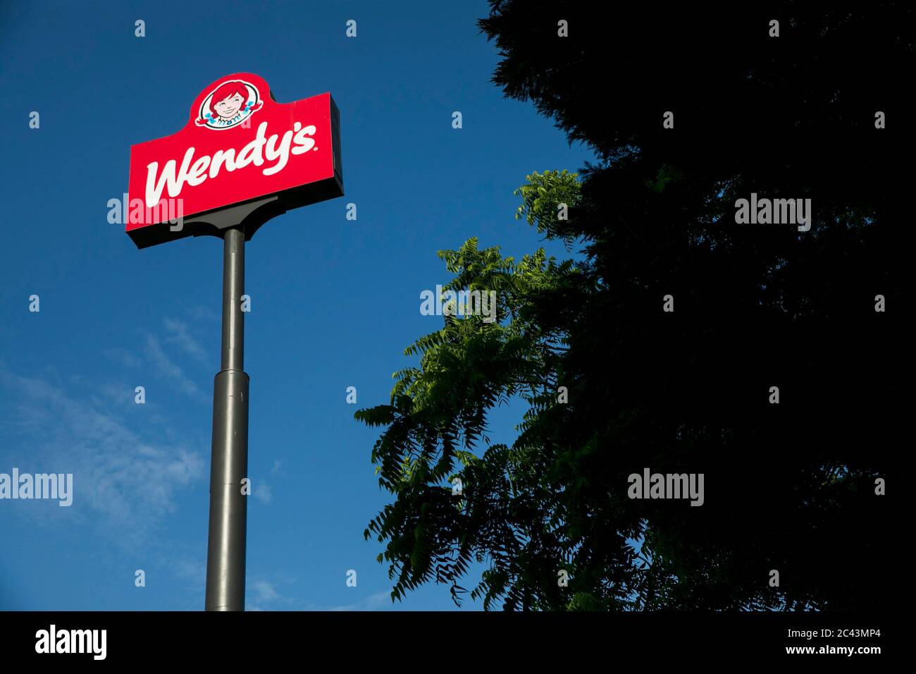 A logo sign outside of a Wendy's restaurant location in Hagerstown, Maryland on June 10, 2020. Stock Photo
