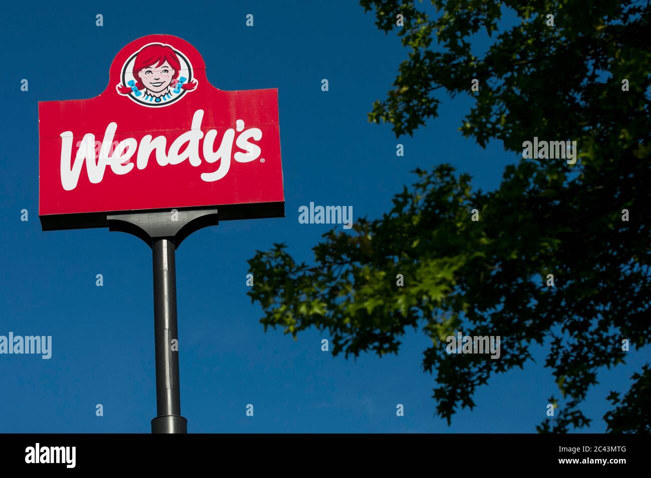 A logo sign outside of a Wendy's restaurant location in Hagerstown, Maryland on June 10, 2020. Stock Photo