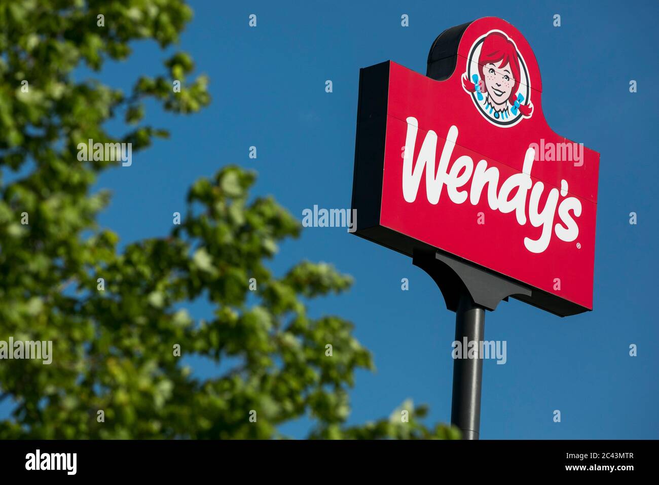 A logo sign outside of a Wendy's restaurant location in Hagerstown, Maryland on June 10, 2020. Stock Photo