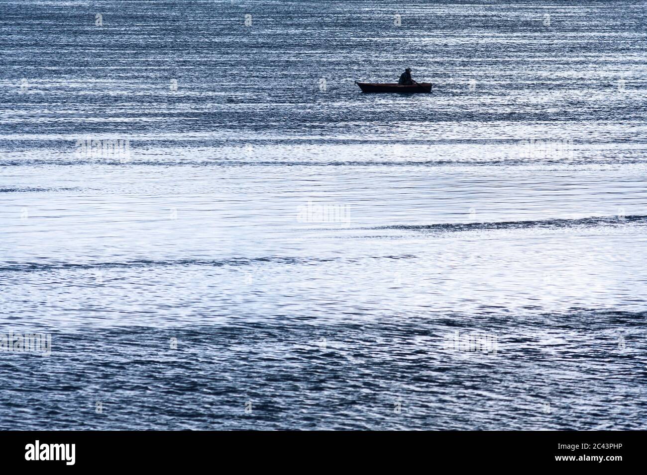 silhouette of fishermen in boat on the river Stock Photo - Alamy