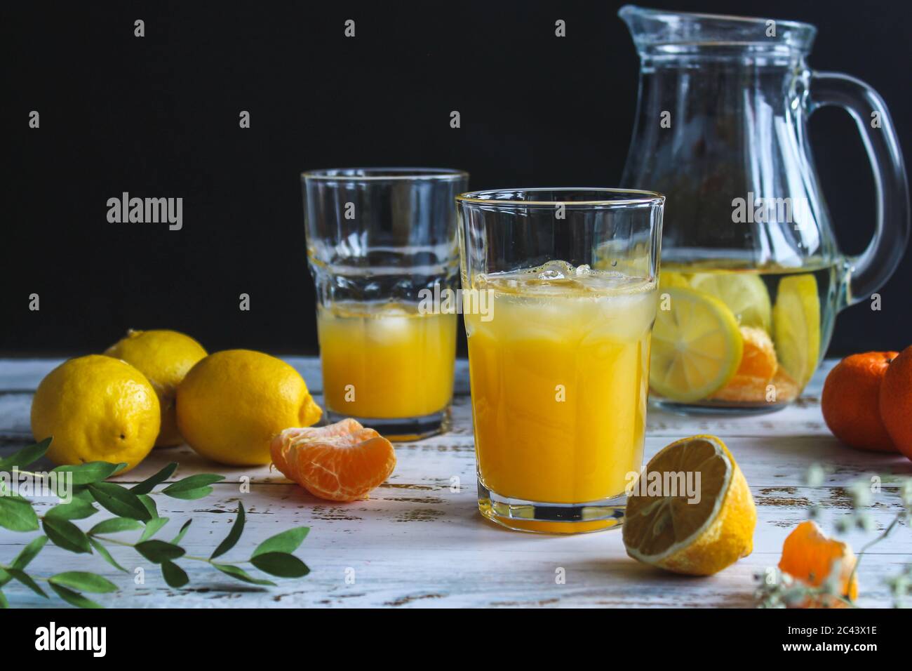 Glass of fresh orange juice with fresh fruits on wooden table Stock Photo