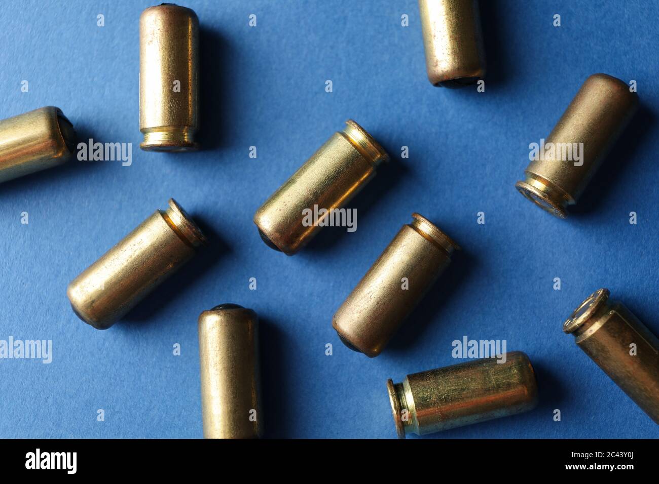 Rubber bullets on blue background, top view. Self defense weapon Stock Photo