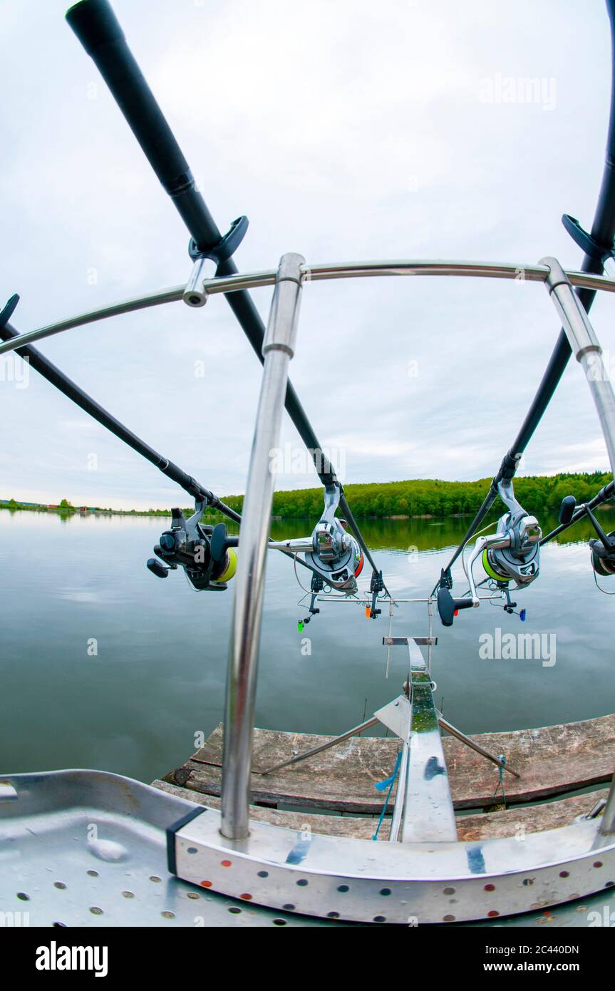 Fishing equipment for sport fishing. Carp rods with a coil mounted on a handmade support system Stock Photo
