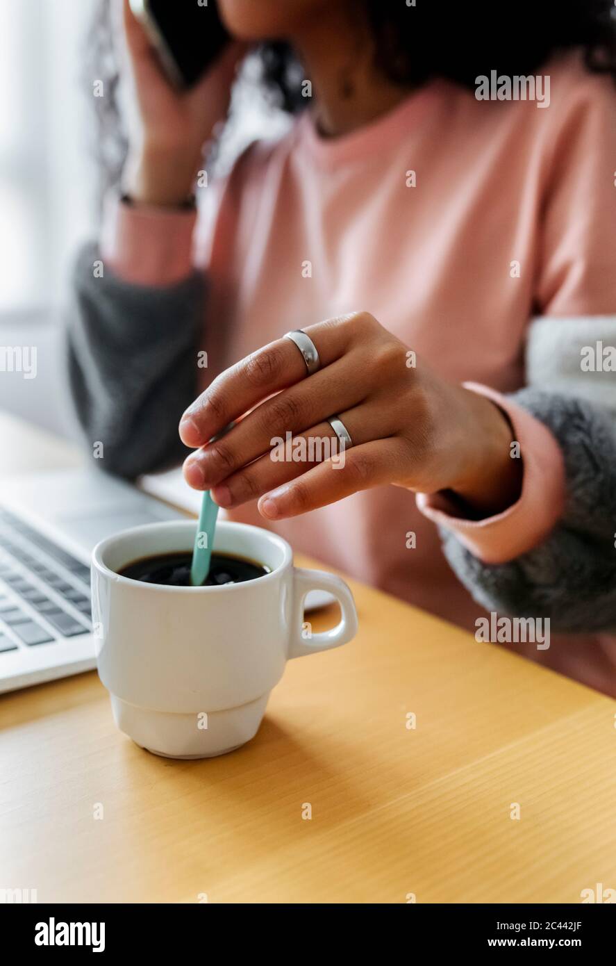 Close-up of young woman sitting at tablet working from home Stock Photo