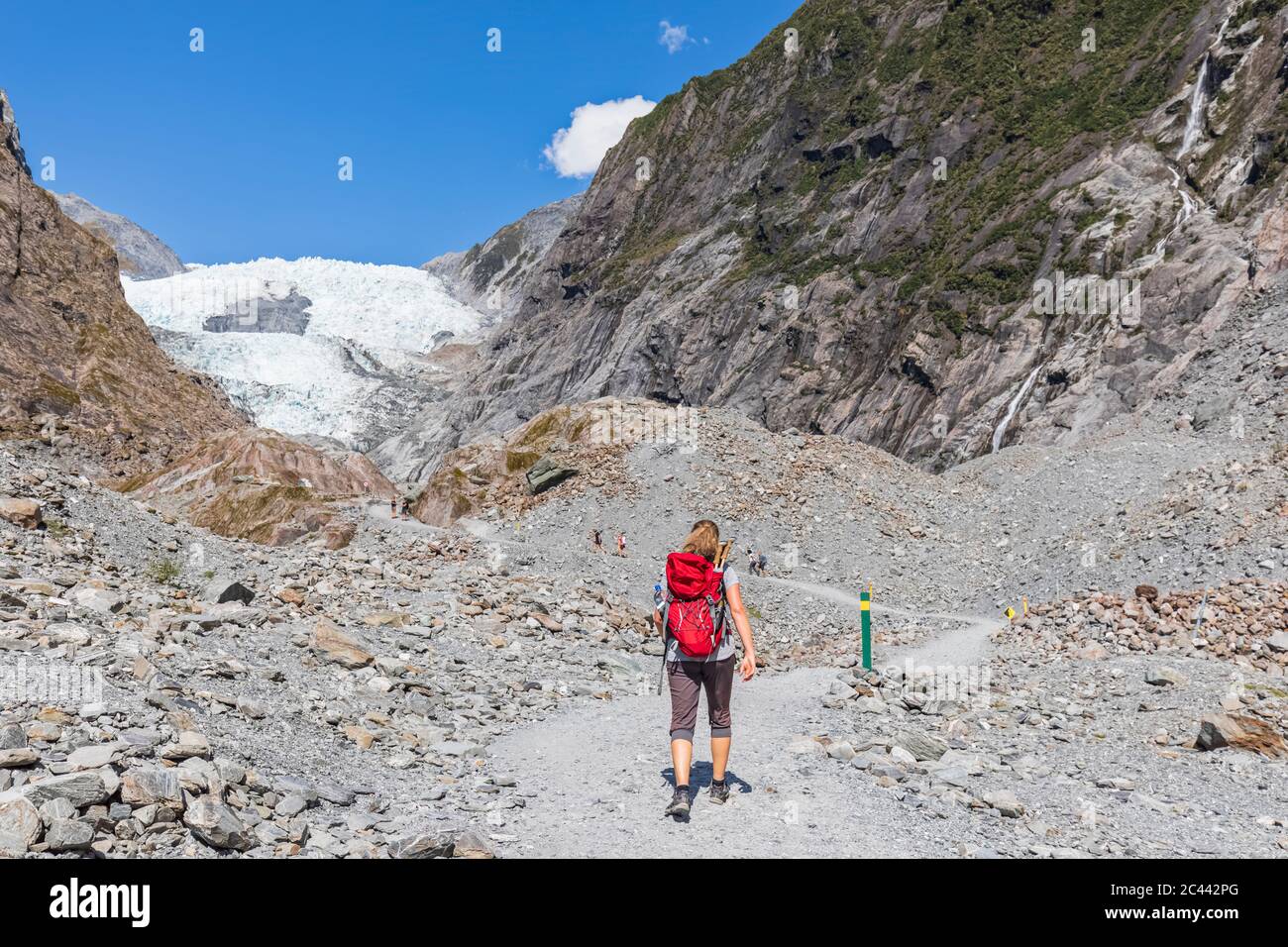 New Zealand, Westland District, Franz Josef, Female backpacker hiking in Franz Josef Glacier Stock Photo