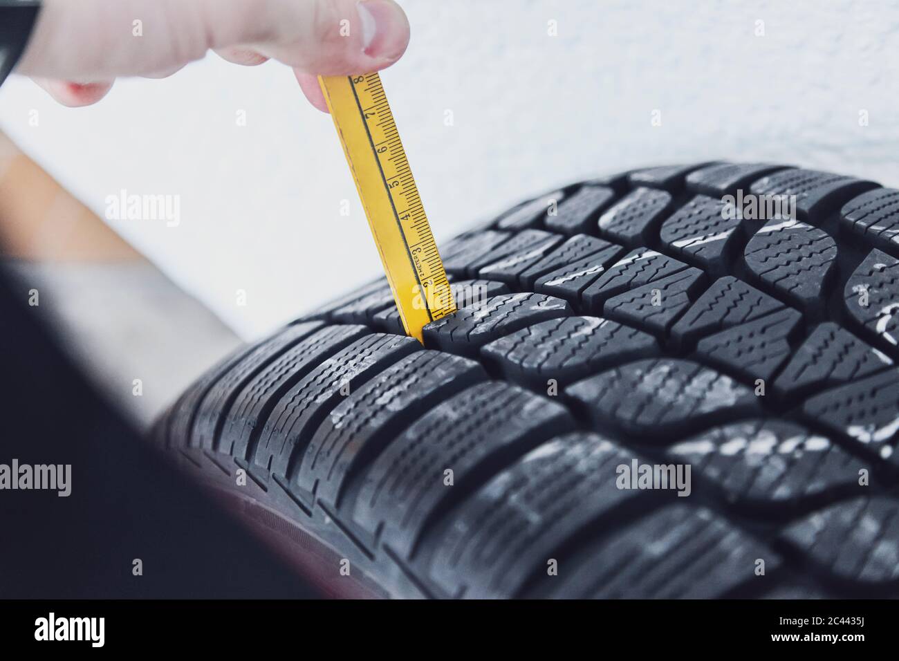Close-up of winter tire being checked Stock Photo