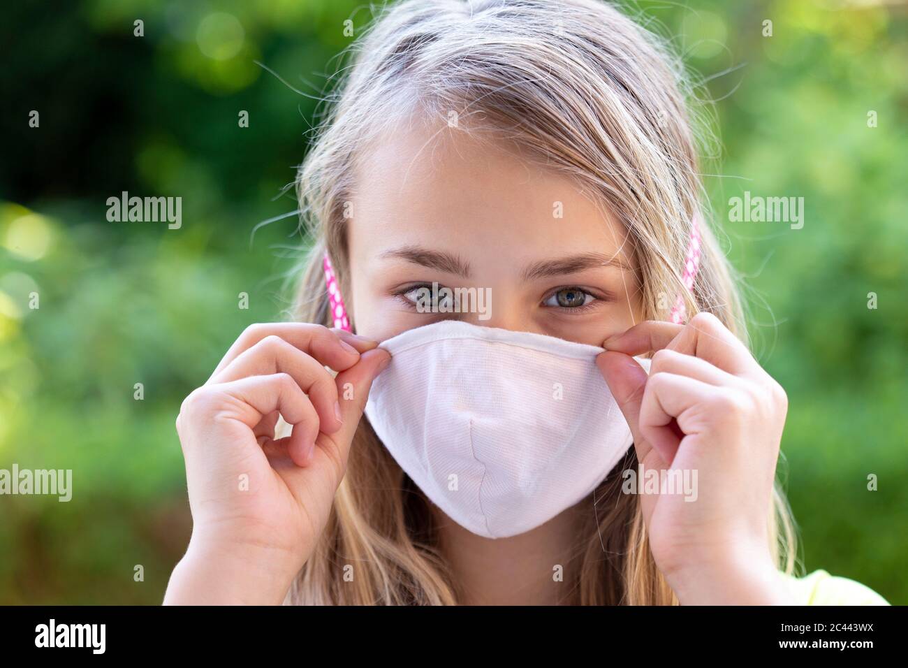Close-up of girl wearing face mask Stock Photo