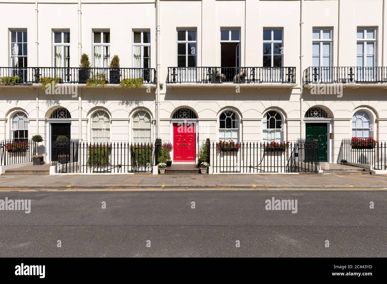 UK, London, White building red and black doors in empty street  during curfew Stock Photo