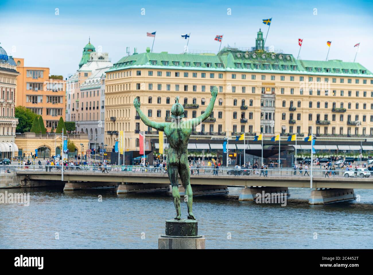 Sweden, Sodermanland, Stockholm, Back of Solsangaren statue with bridge and luxurious hotel in background Stock Photo