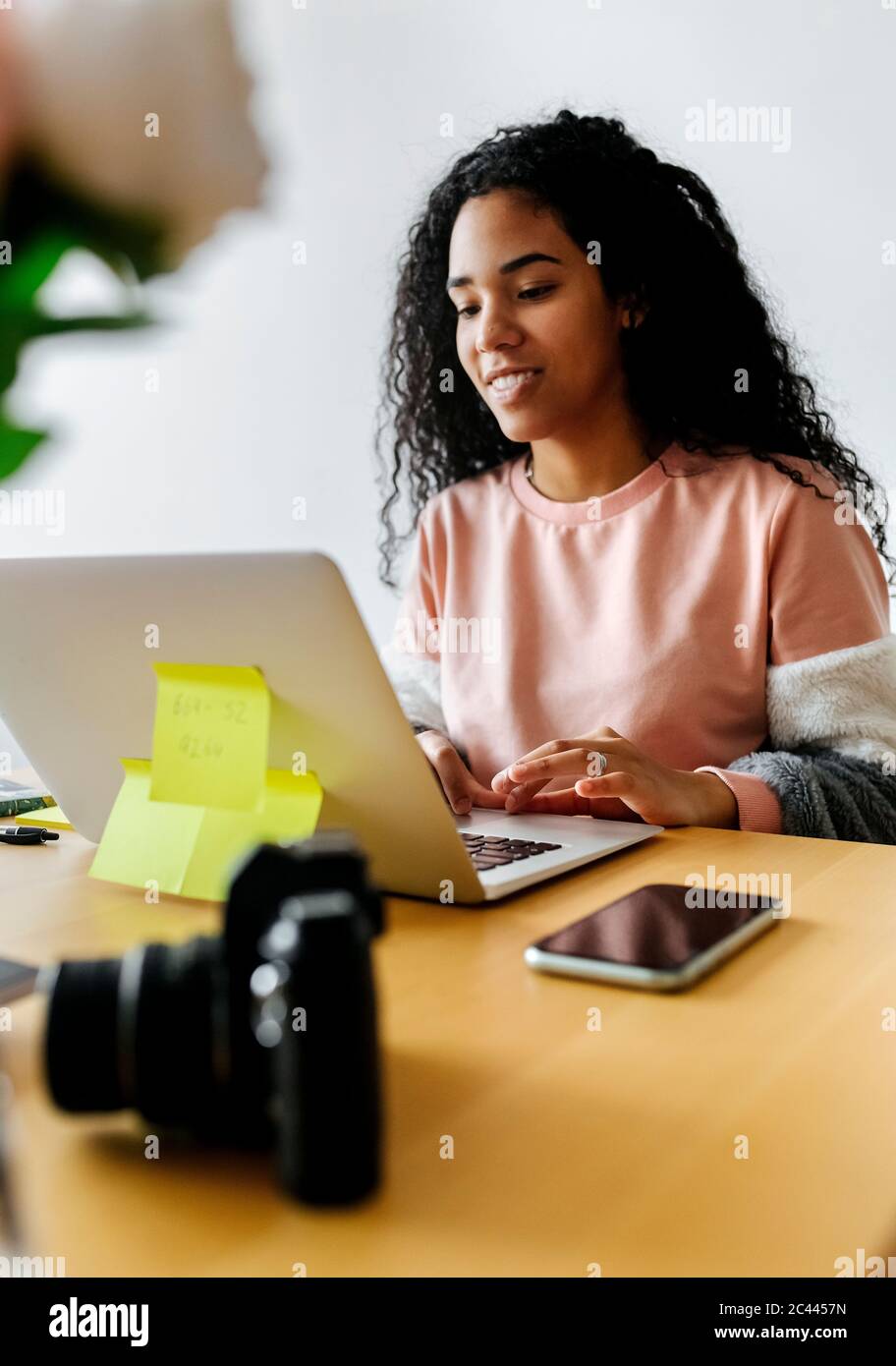 Young woman working from home using laptop Stock Photo