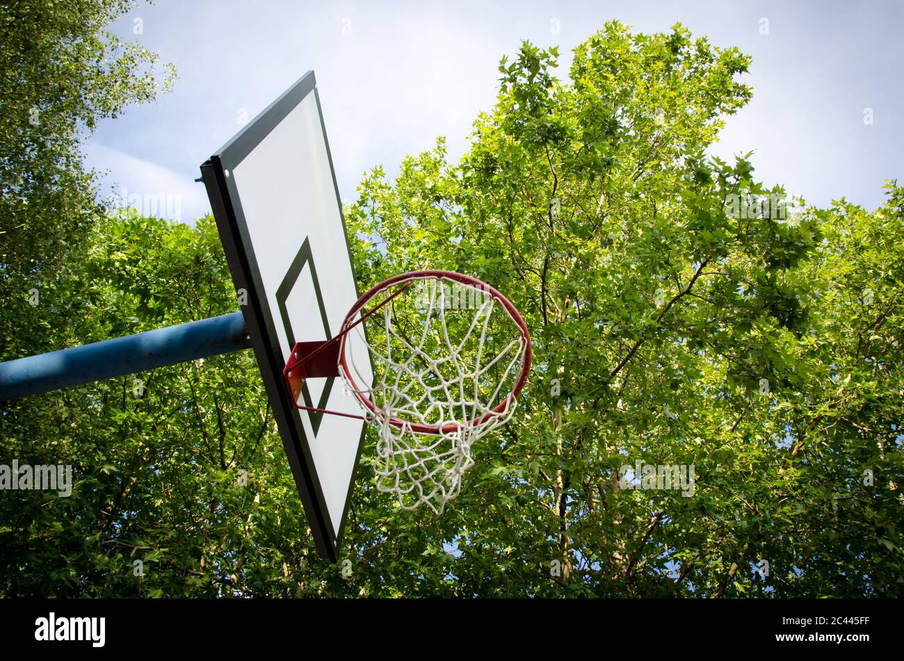 detail of basketball board with red hoop with net , down view with