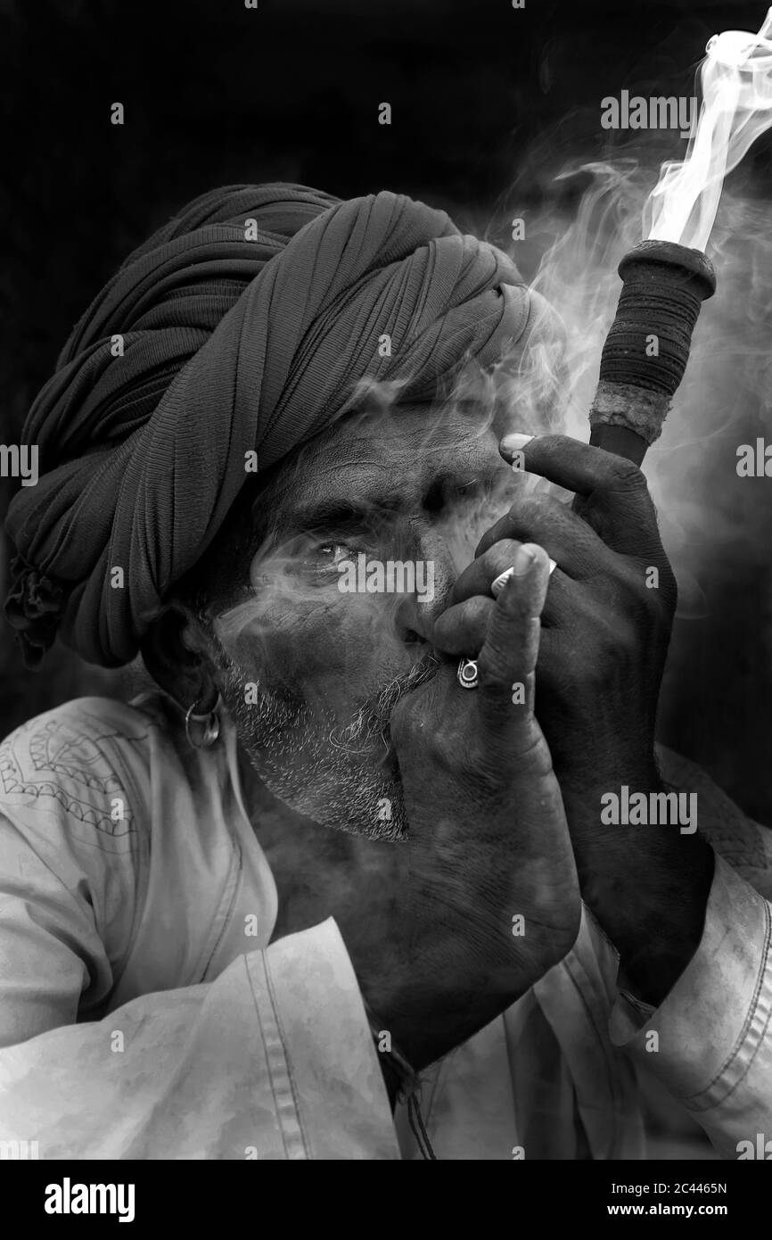 The image of Shepherds smoking  in the village of Jawai-Bera, Rajasthan, India, asia Stock Photo