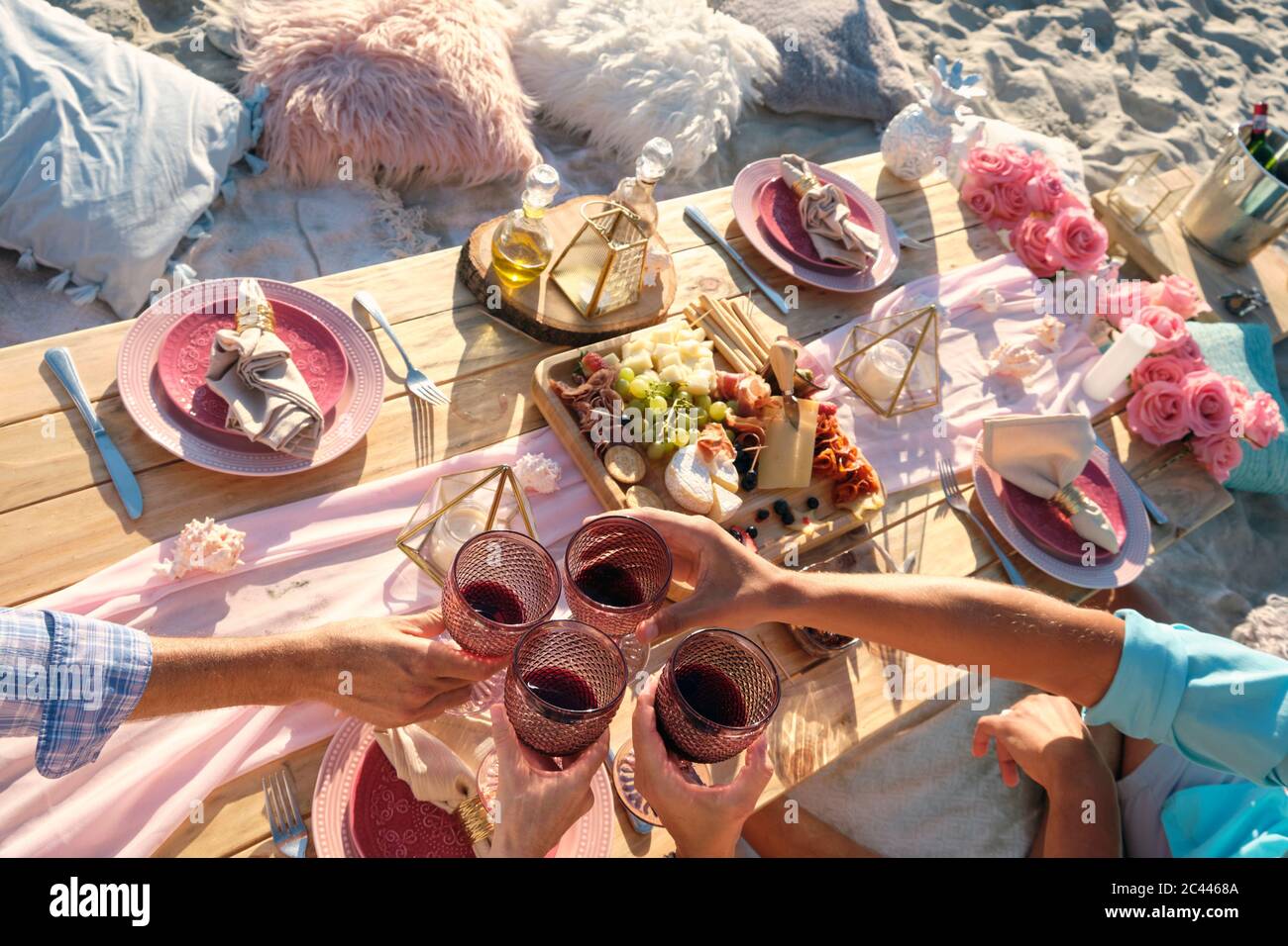 Luxury beach picnic close up with multiple people and a delicious