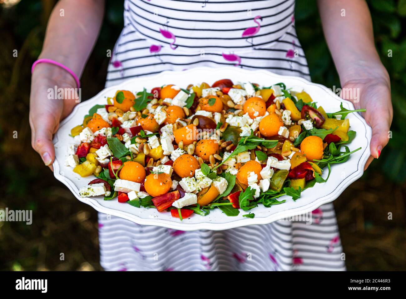 Midsection of woman holding plate with healthy salad Stock Photo