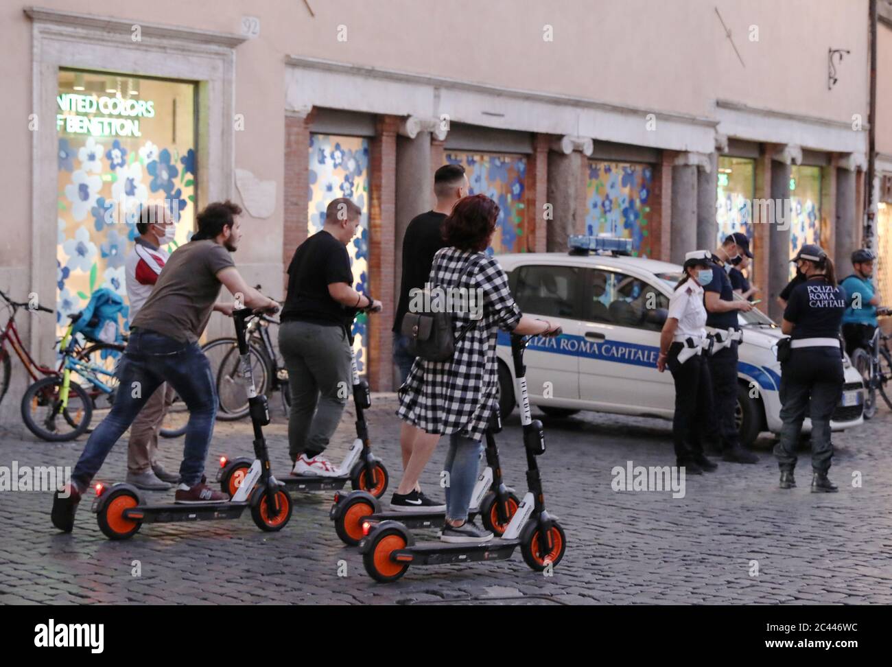 Rome, Italy. 23rd June, 2020. People ride electric scooters in Rome, Italy, June 23, 2020. As Italy continues to ease coronavirus lockdown rules, pedestrians returning to the streets are finding themselves competing for space with a kind of vehicle that hardly existed in the country before the lockdown -- electric scooters.TO GO WITH 'Feature: E-scooters enter into Italian city streets amid pandemic, fail to please all' Credit: Cheng Tingting/Xinhua/Alamy Live News Stock Photo