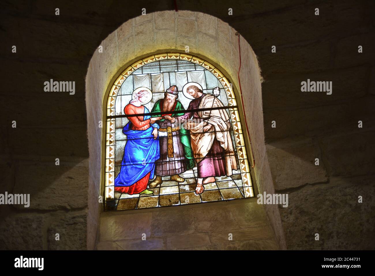 A glass painting on the church showing Joseph and Mary getting married in front of a priest