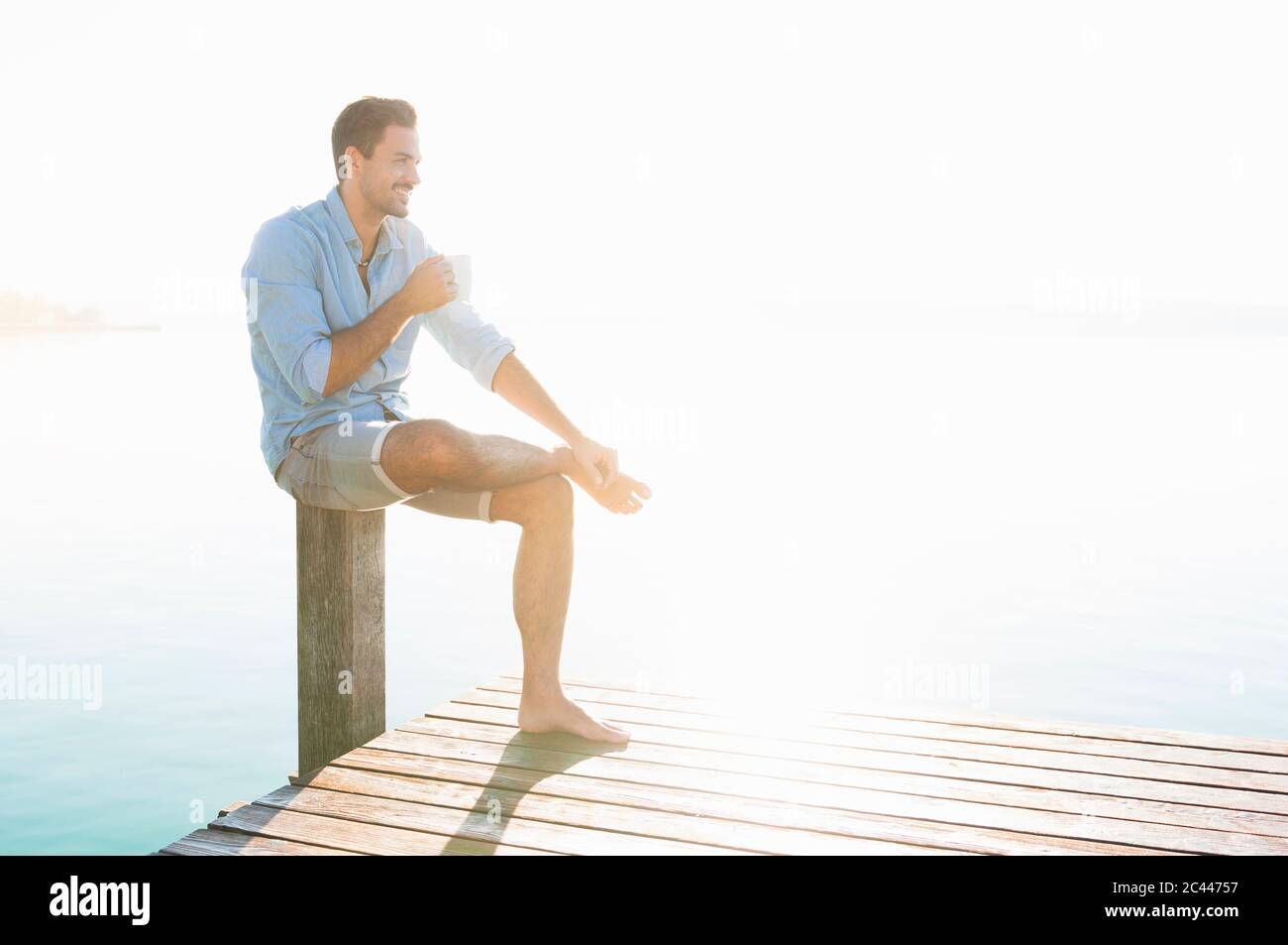 Young man sitting on pole hi-res stock photography and images - Alamy