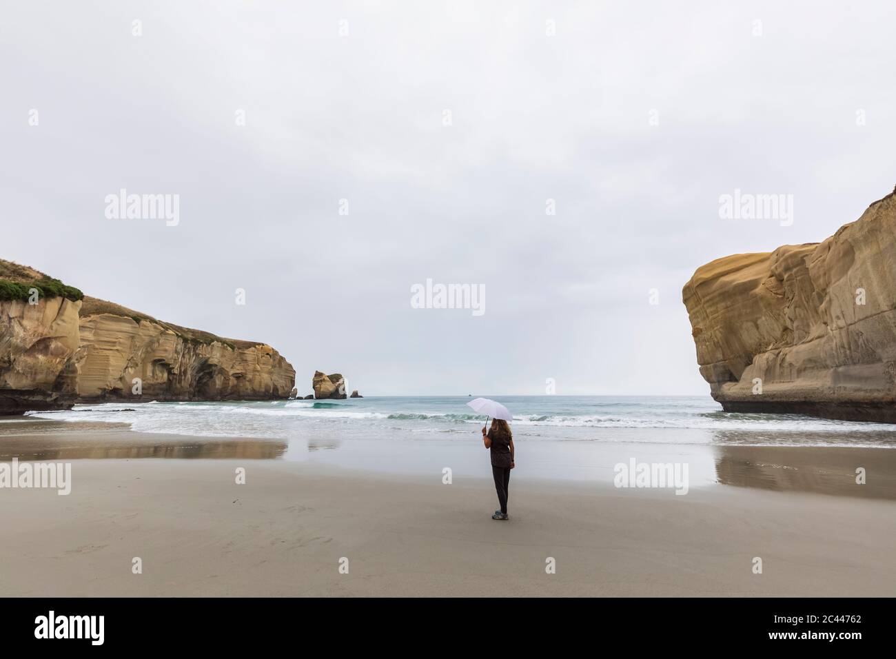 New Zealand, Oceania, South Island, Otago, Dunedin, Woman with umbrella