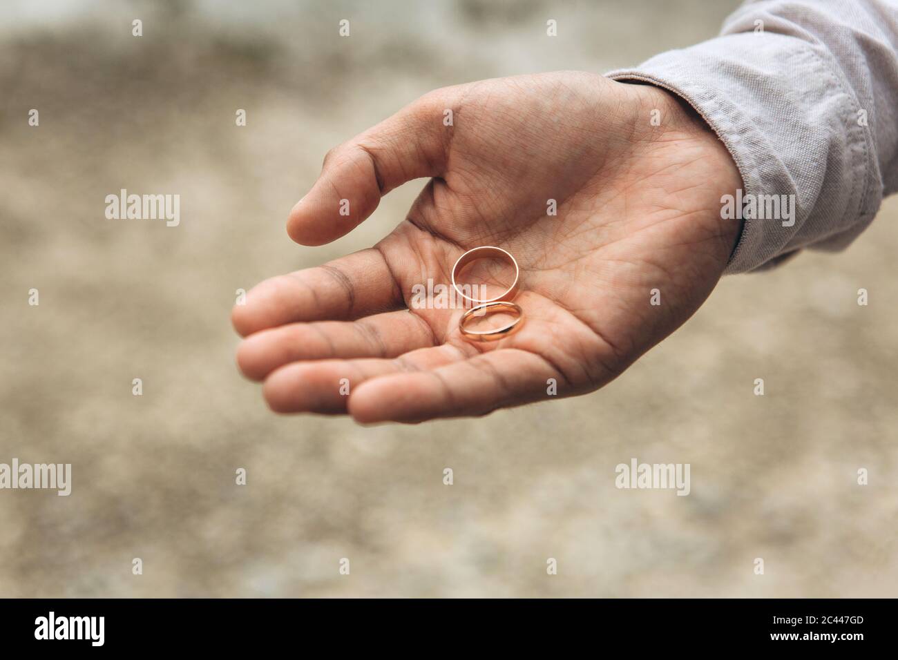 The groom holds a wedding ring in his hand Stock Photo Alamy