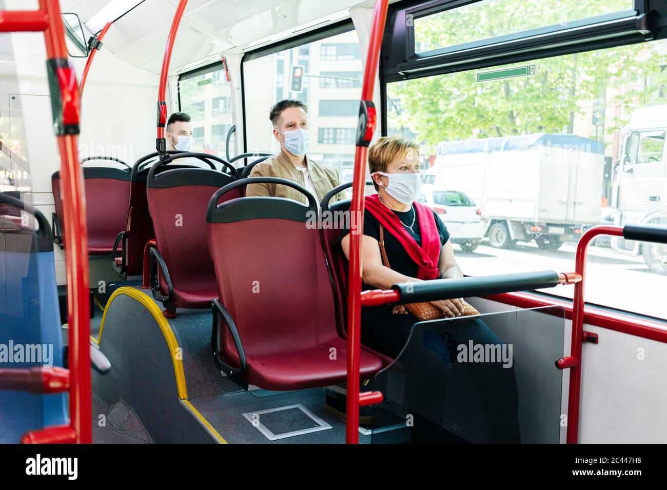 Passengers wearing protective masks in public bus, Spain Stock Photo