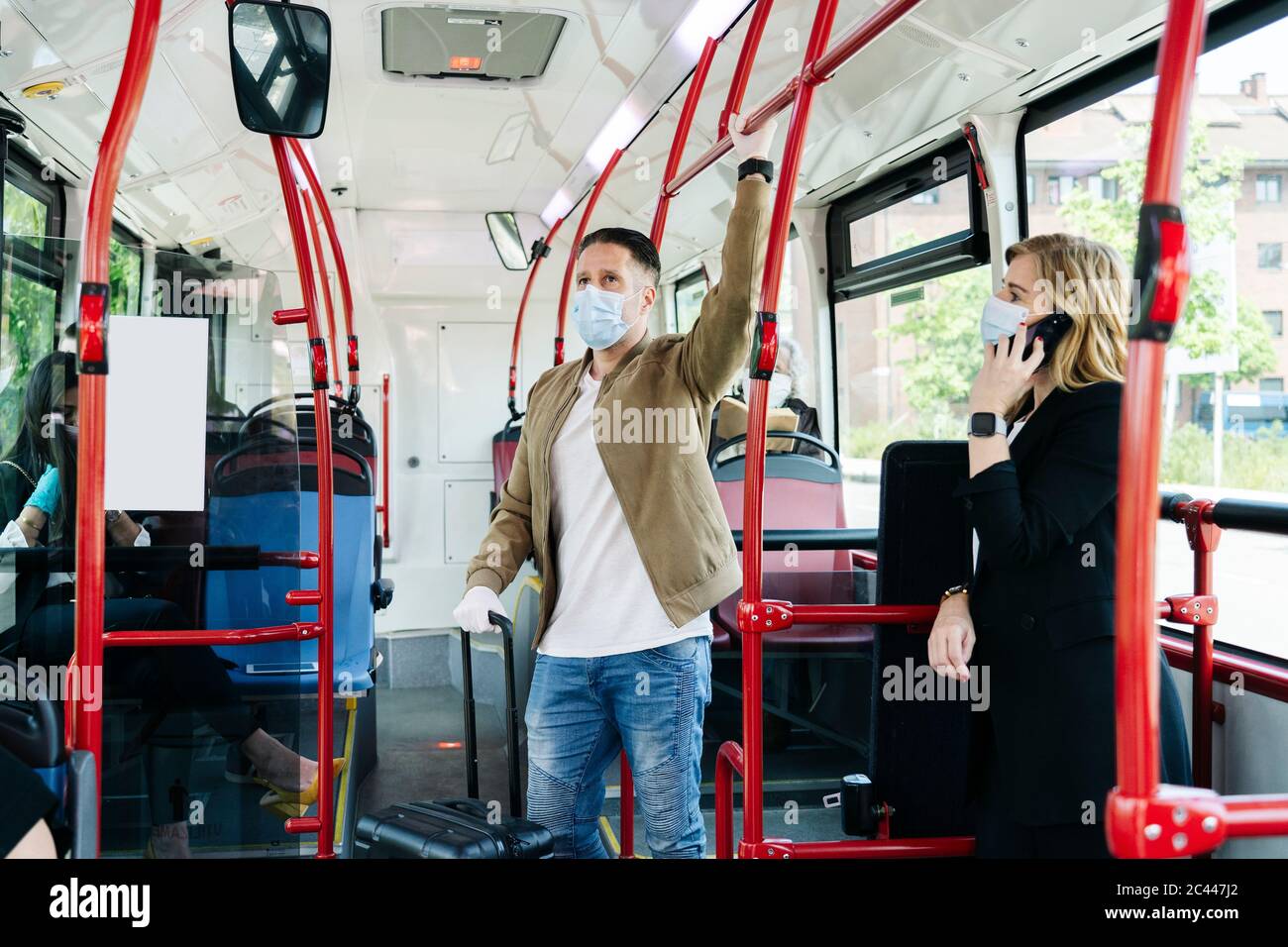 Passengers wearing protective masks in public bus, Spain Stock Photo