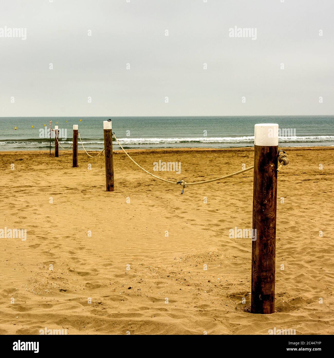 Aligned wooden stakes on the beach,  Mediterranean sea , France Stock Photo