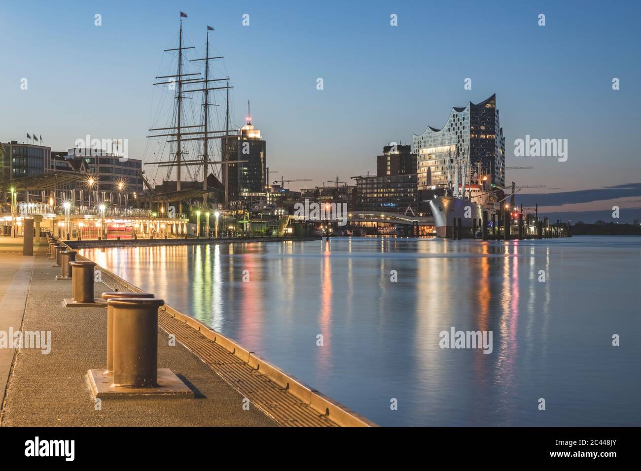 Germany, Hamburg, Bollards along Saint Pauli Piers with Rickmer Rickmers ship and Elbphilharmonie in background Stock Photo