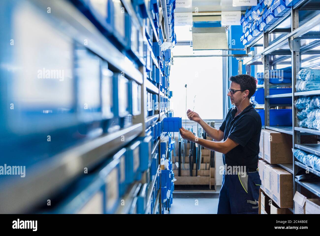 Man in storage room of a factory Stock Photo