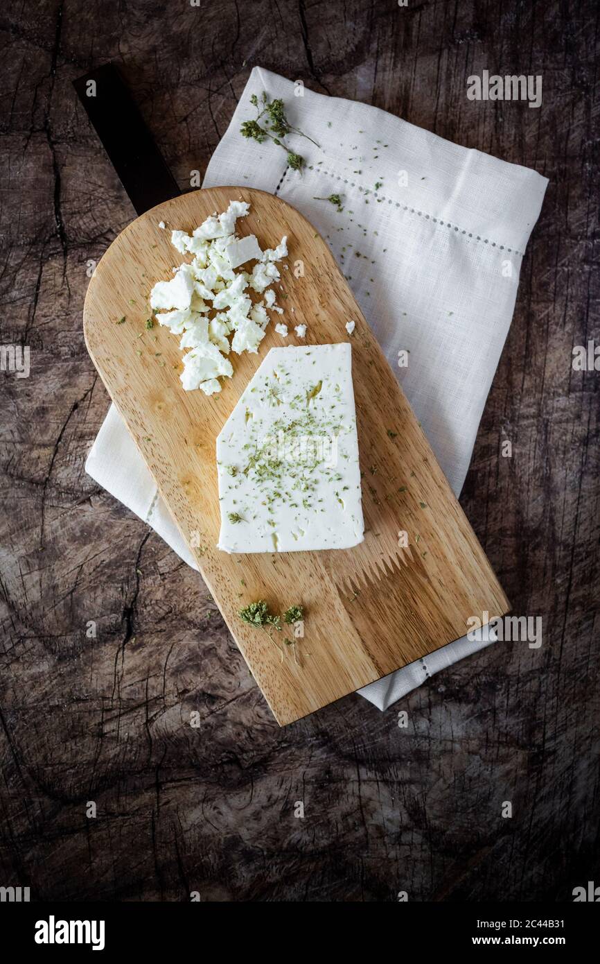 Feta cheese on cutting board Stock Photo