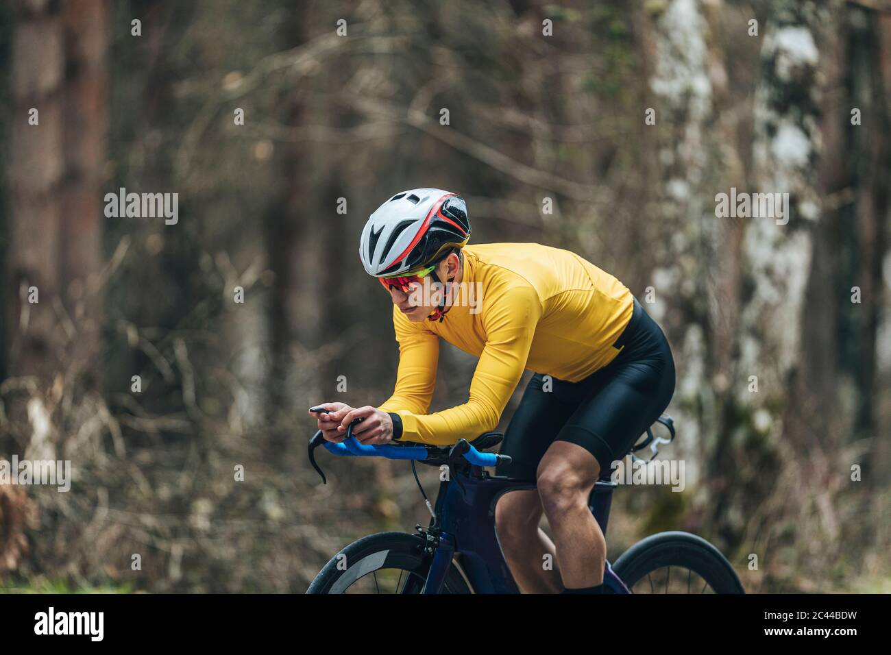 Young man in sports clothing riding bicycle Stock Photo
