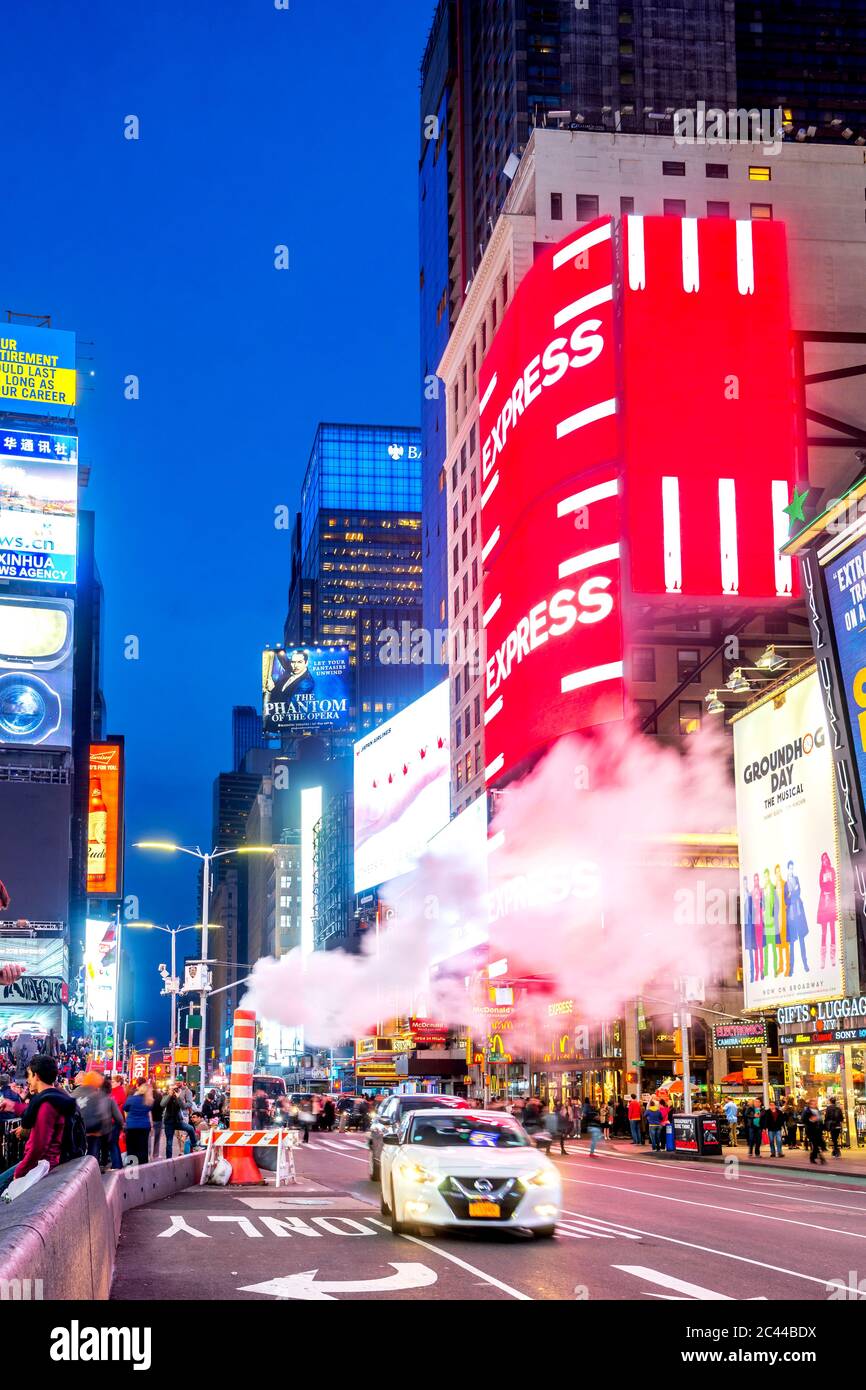 USA, New York, New York City, Smoke floating over cars passing through Times Square at dusk Stock Photo