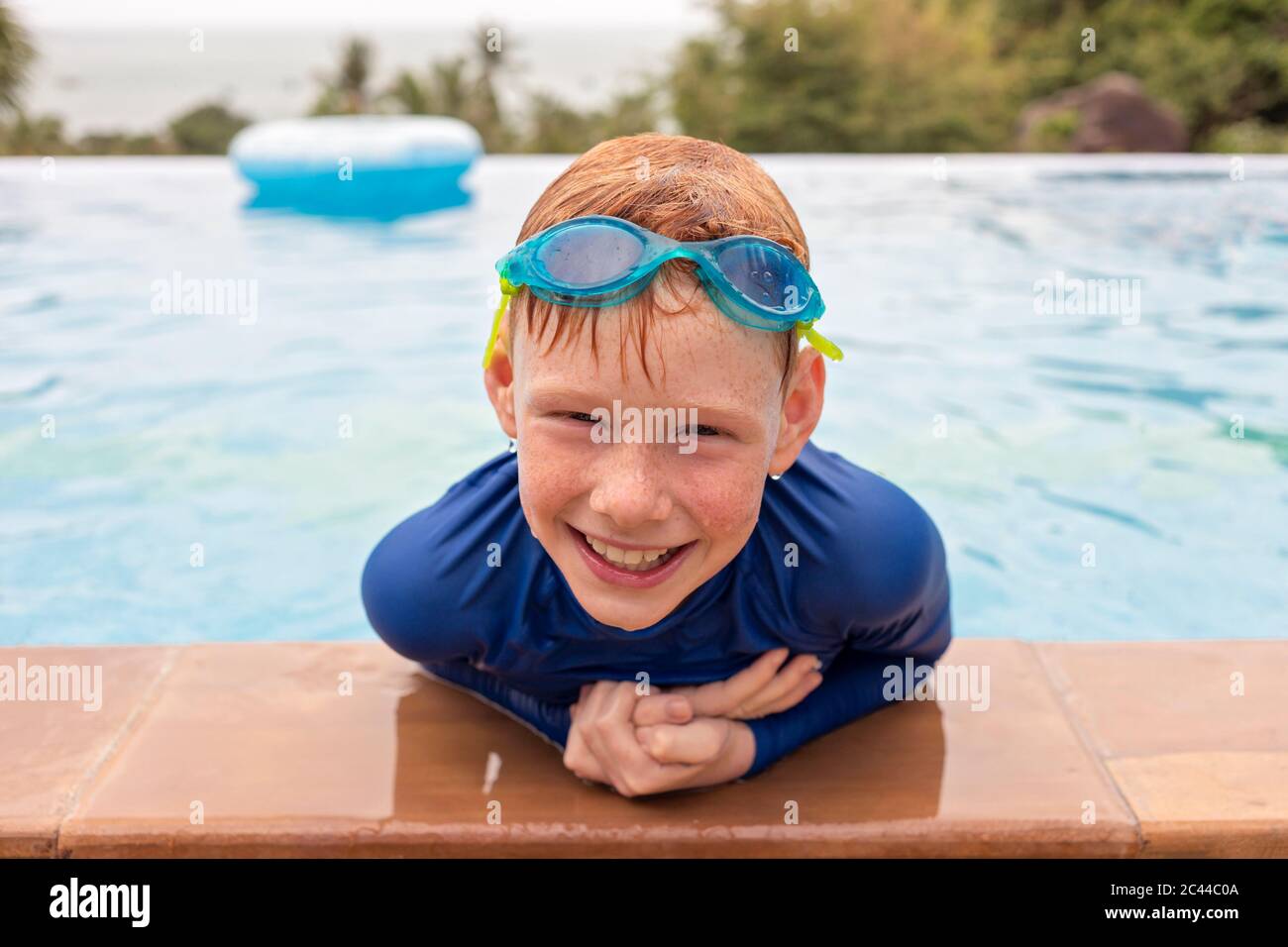 Close-up portrait of smiling boy playing in swimming pool, Thailand, Asia Stock Photo