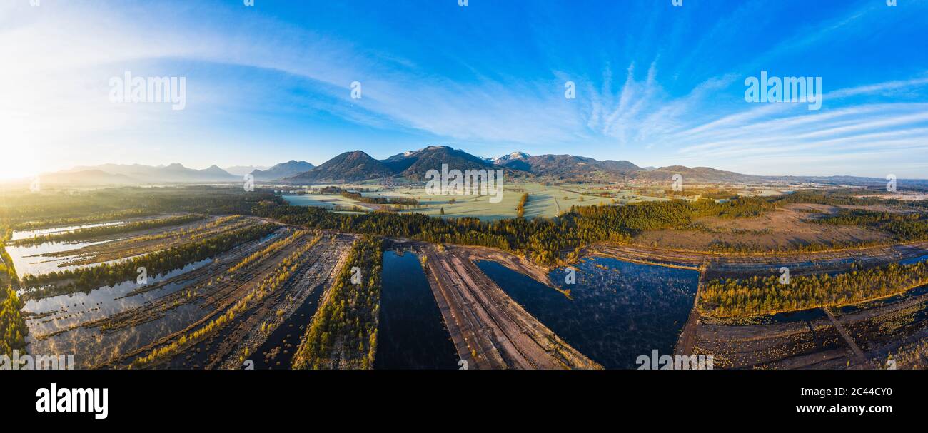 Germany, Bavaria, Aerial panorama of restored moor between Raubling and Bad Feilnbach at sunrise Stock Photo