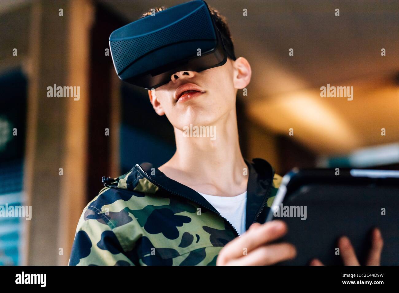 Man looking through virtual reality simulator in city Stock Photo