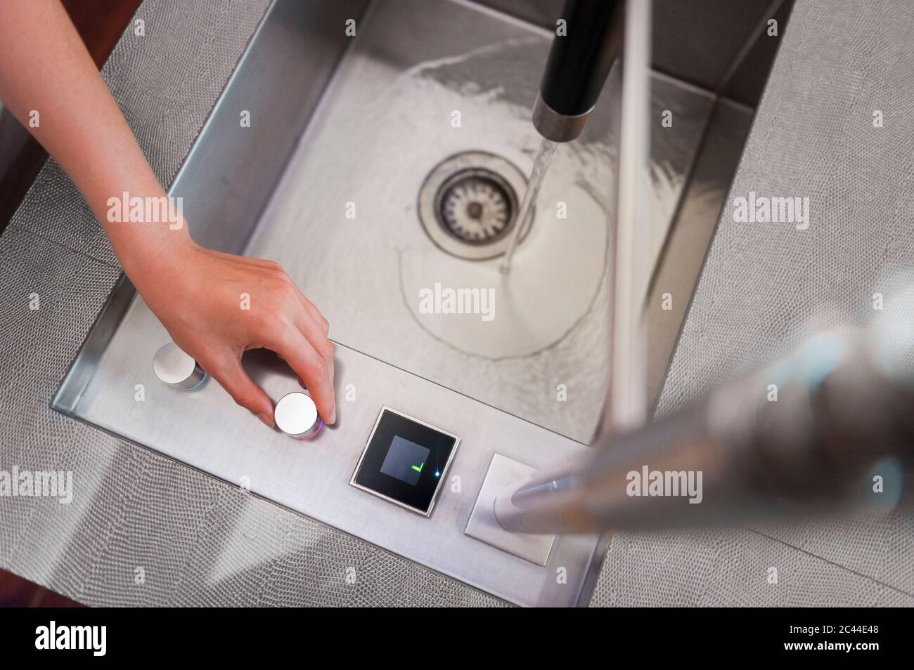Hand of woman turning off faucet in kitchen Stock Photo Alamy