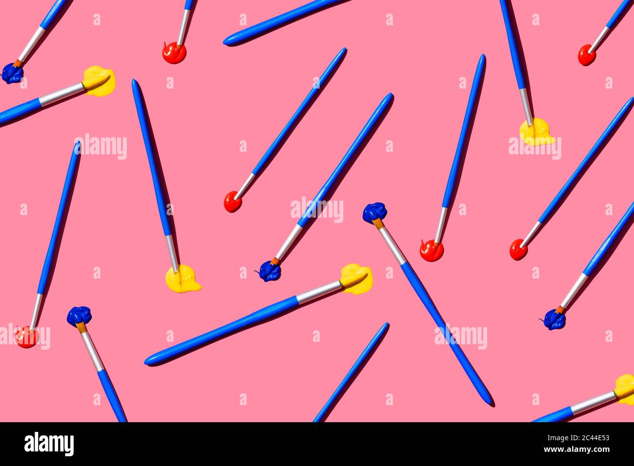 Pattern of paintbrushes with blue, red and yellow oil paint Stock Photo