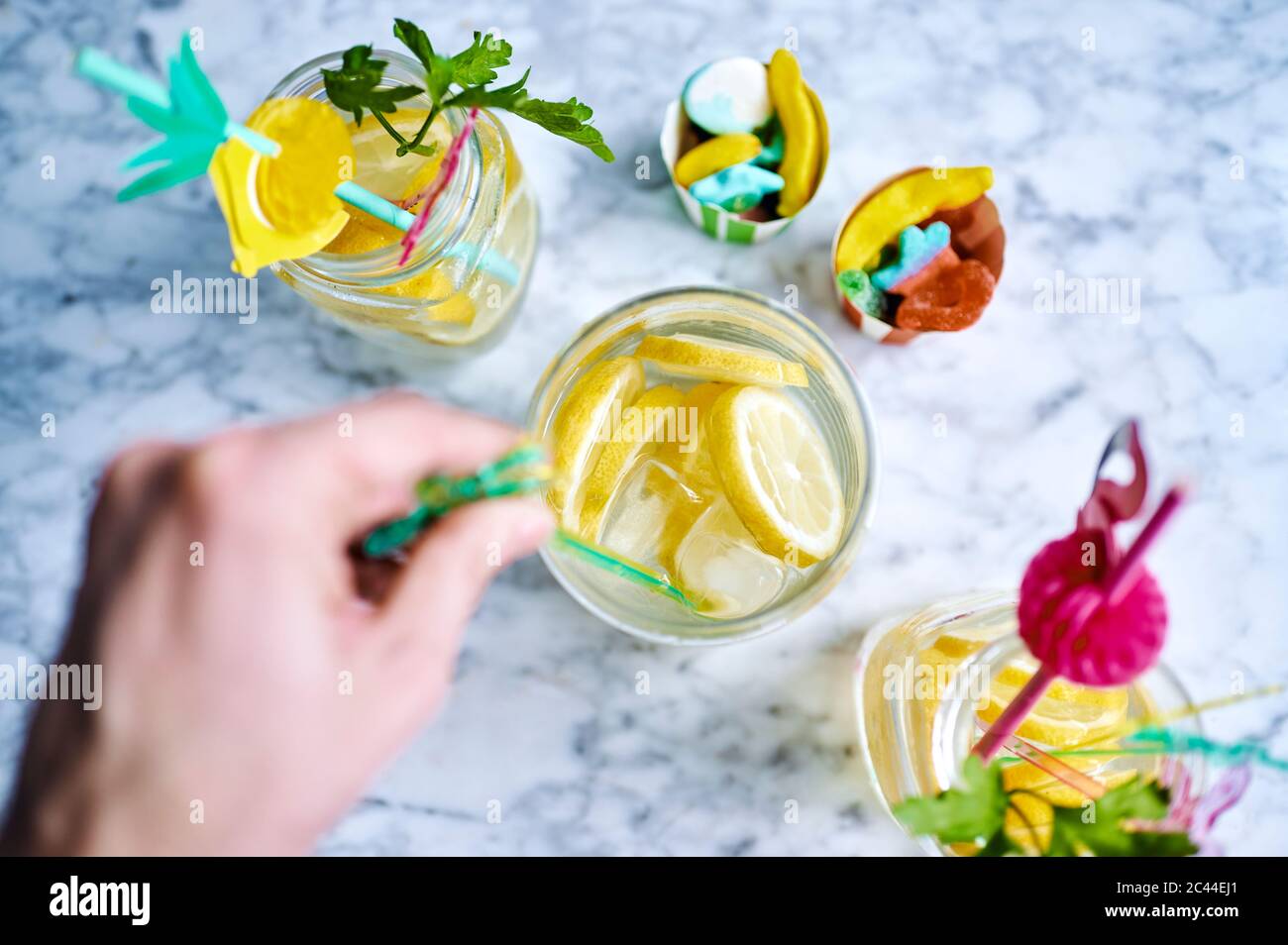 Hands of woman stirring fresh lemonade Stock Photo