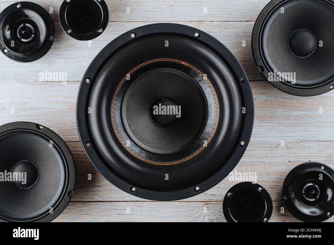 Car audio, car speakers, black subwoofer on a white wooden background. Close up Stock Photo