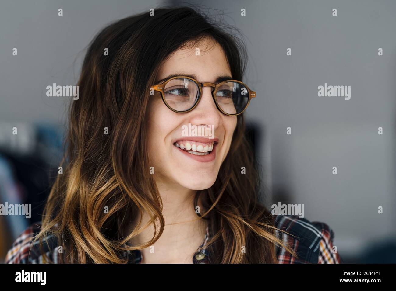 Portrait of laughing young woman wearing glasses Stock Photo