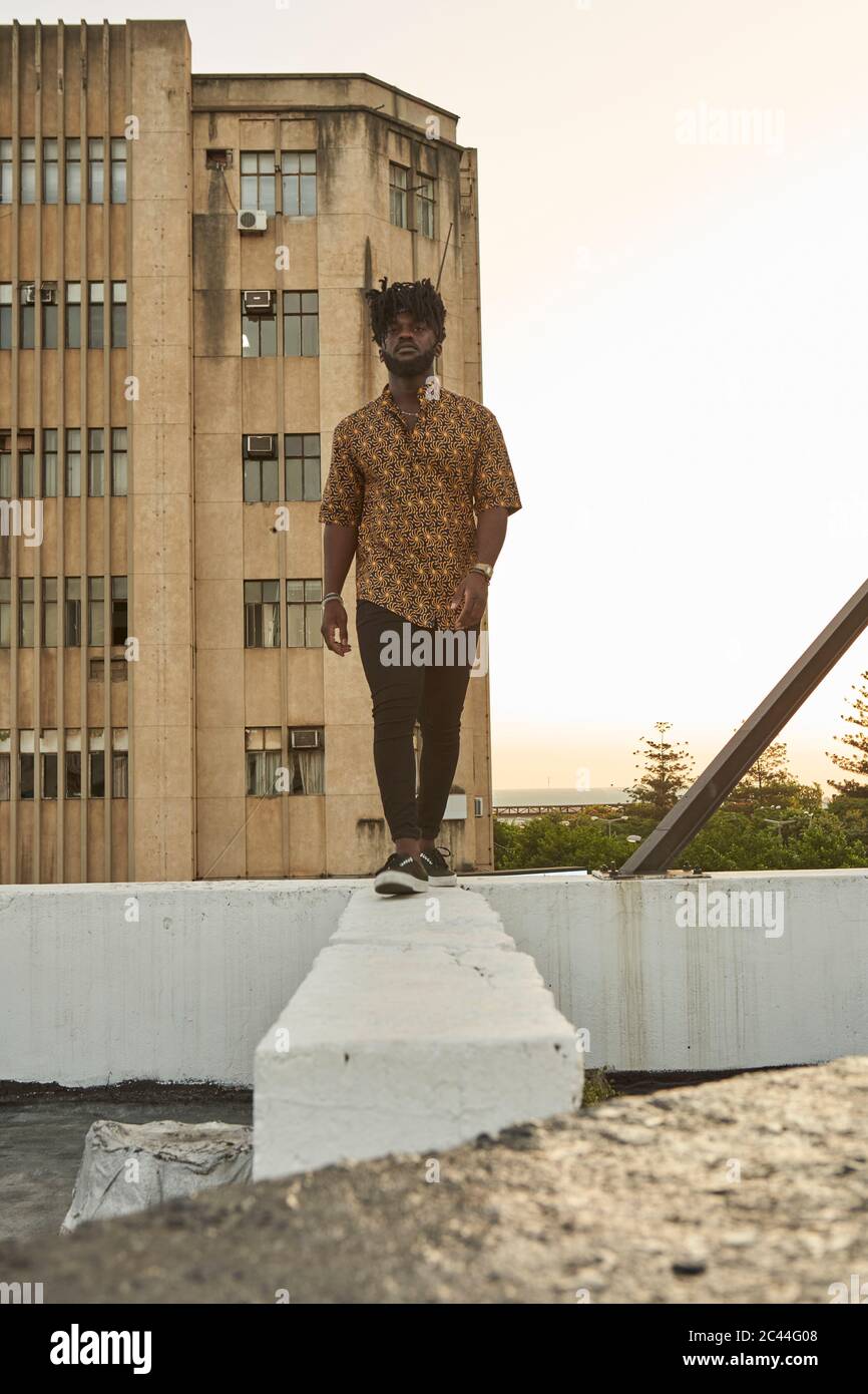Young black african man walking hi-res stock photography and images - Alamy