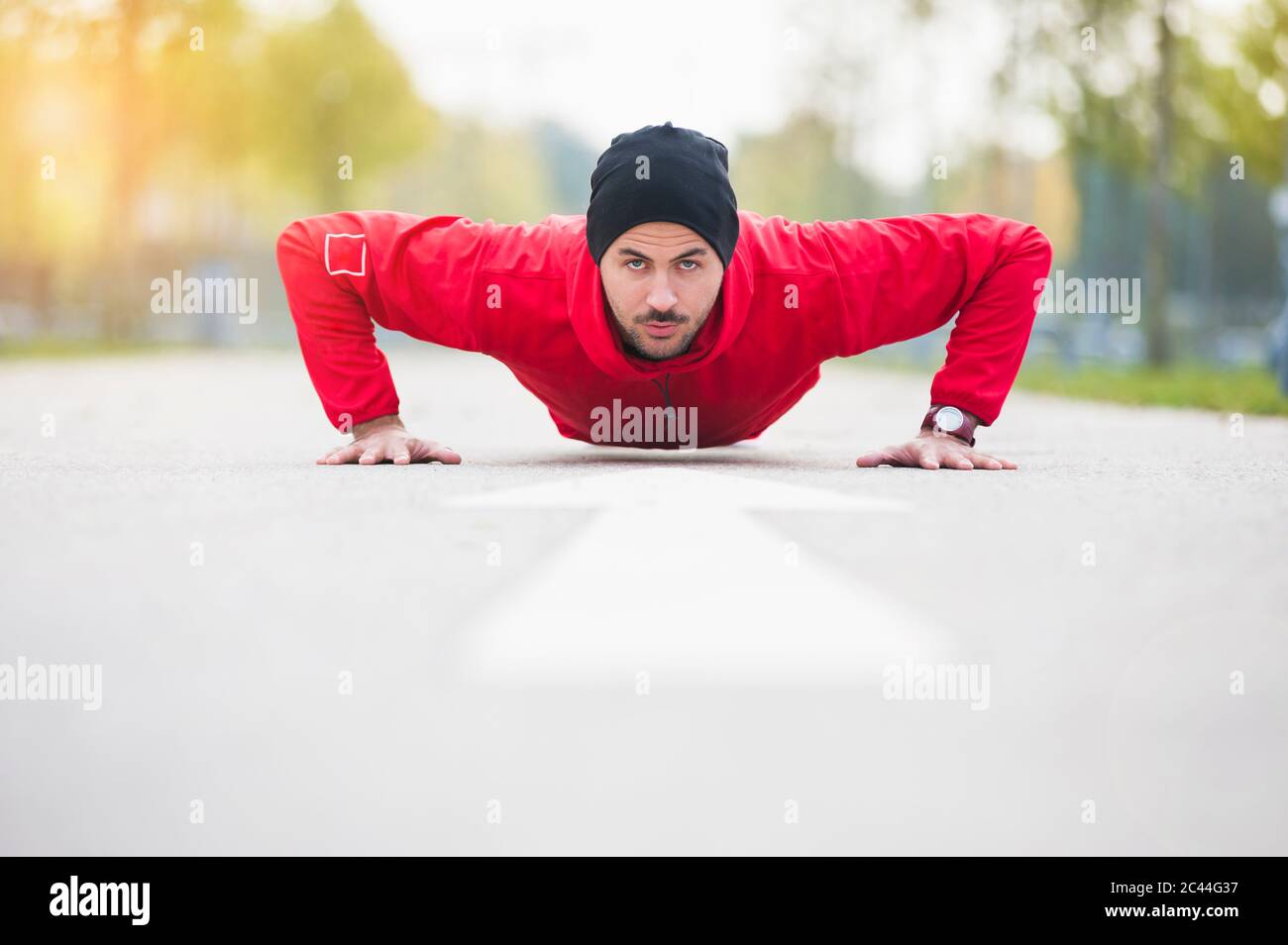 Young man doing push-ups on a lane Stock Photo