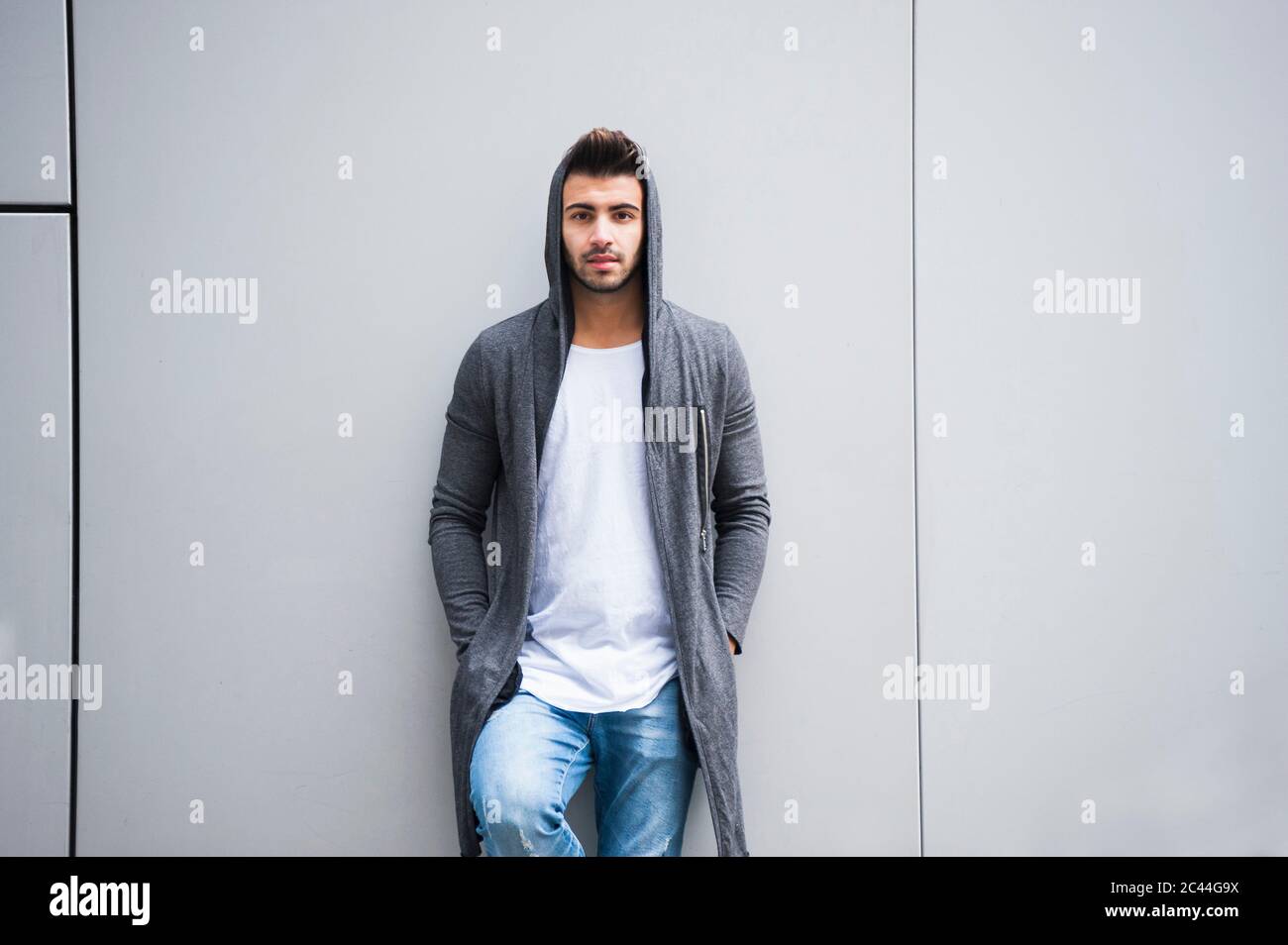 Fashionable young man standing against wall Stock Photo