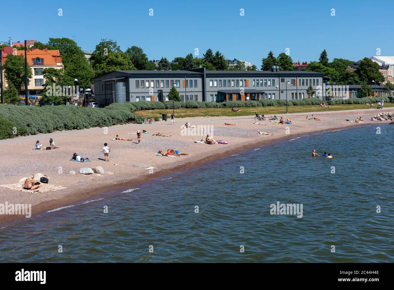 People sun bathing and swimming in Eiran ranta beach in Helsinki, Finland Stock Photo