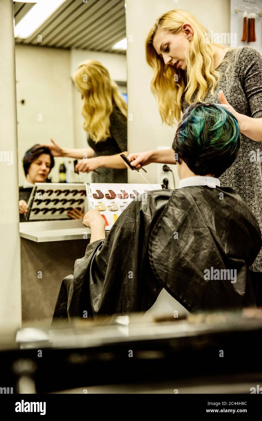 Hairdresser showing colour samples to colour hair Stock Photo Alamy