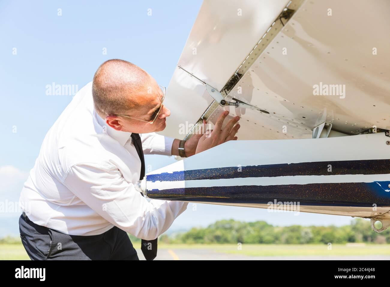 Pilot doing pre flight inspection on his sports plane Stock Photo