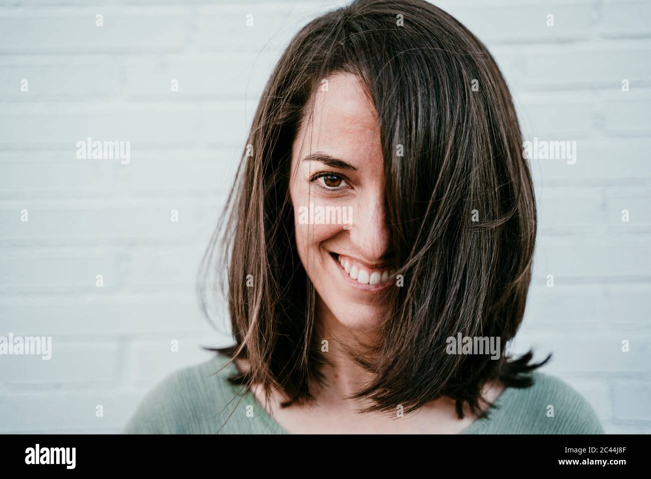 Portrait of happy woman with brown hair Stock Photo