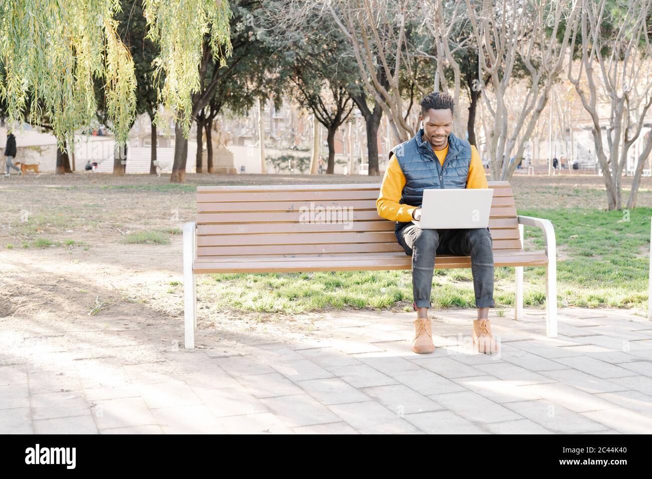 Sitting on park bench hi-res stock photography and images - Alamy