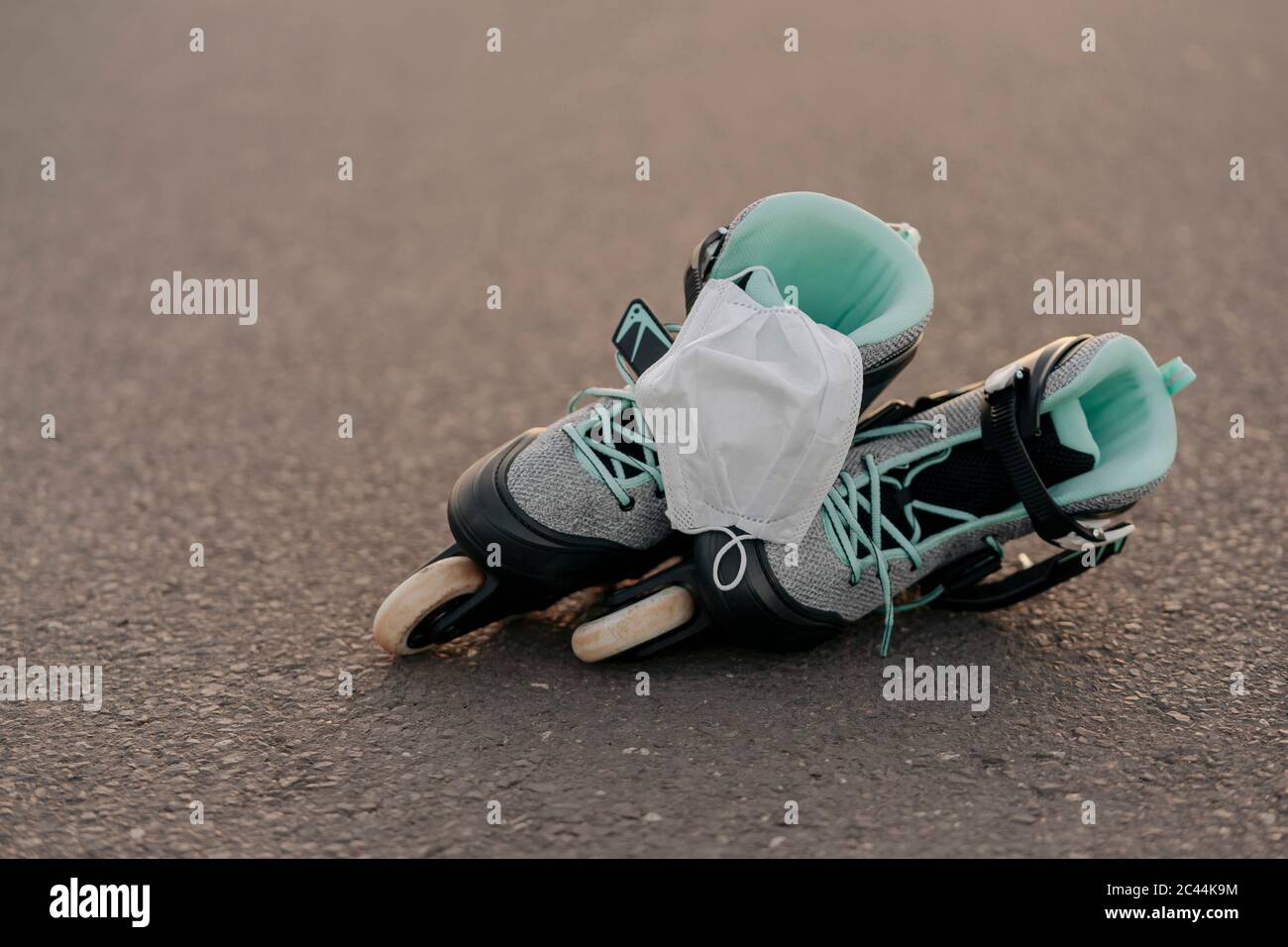 Close-up of face mask on inline skates on at skateboard park Stock Photo