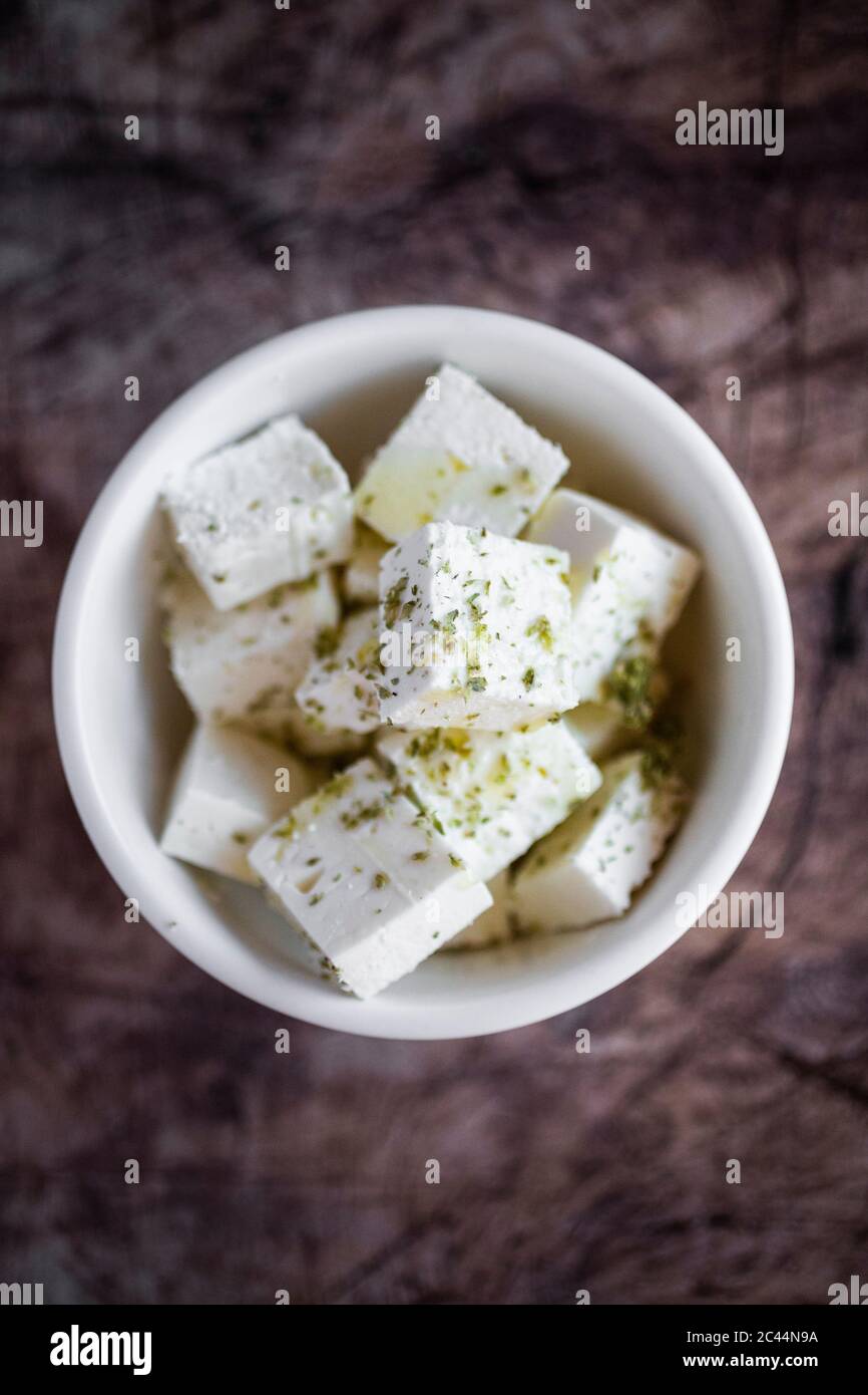 Bowl of sliced feta cheese with olive oil and oregano Stock Photo